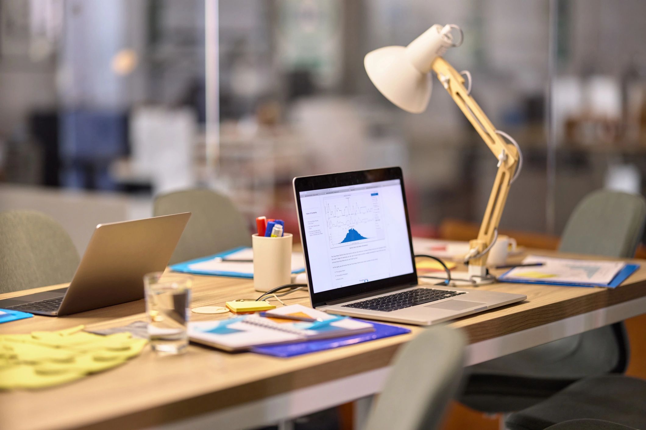 Grant development work with charts and documents on a laptop.